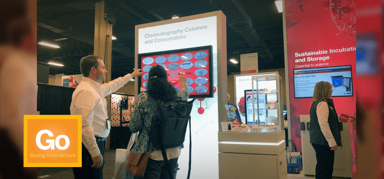 People using a touchscreen game in a trade show exhibit