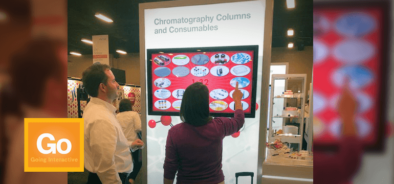 Woman playing touchscreen game in exhibit booth
